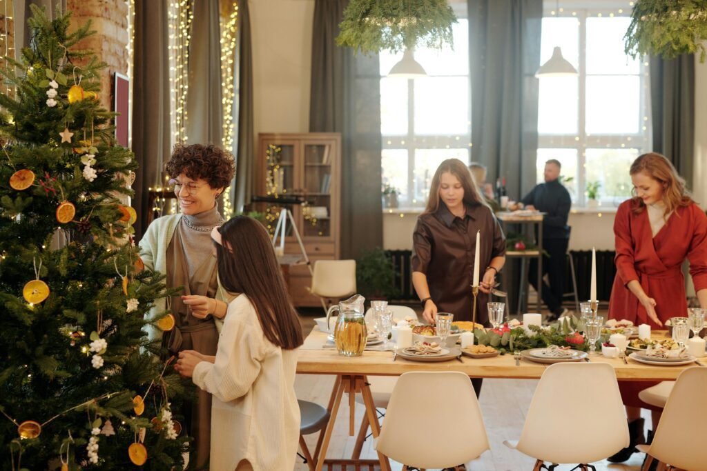 Danish Christmas Traditions - Exploring Danish Christmas Traditions: From Festive Foods to Hygge Celebrations - Career Denmark Festive family gathering decorating a Christmas tree and preparing a holiday meal indoors